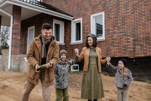 happy family in front of new home