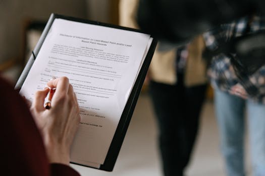 couple signing mortgage agreement with family