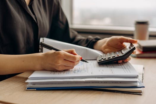 person holding a check and calculator