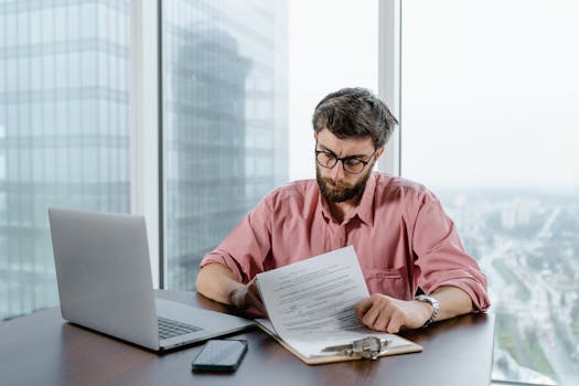 person reviewing mortgage documents on a laptop