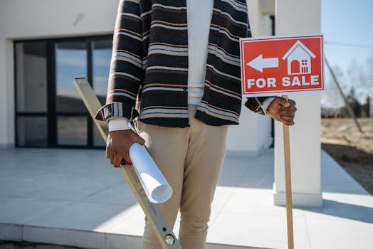 house with a “for sale” sign