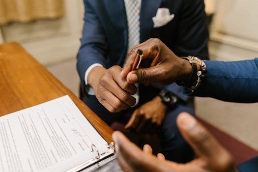 family signing mortgage documents at a closing table