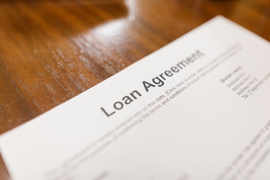 homeowner signing mortgage documents at a table