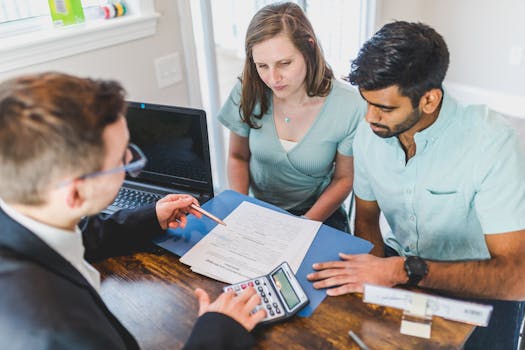 married couple signing mortgage documents