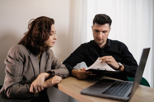 professional couple reviewing mortgage documents