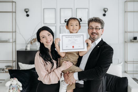 family holding adoption papers