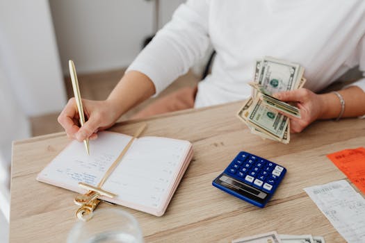 person using a calculator to plan finances