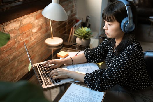 freelancer working on a laptop with client contracts