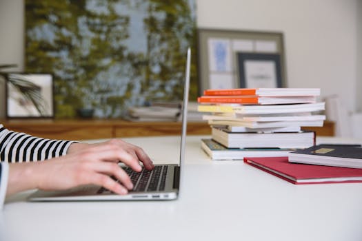 stack of books and a laptop with mortgage-related content